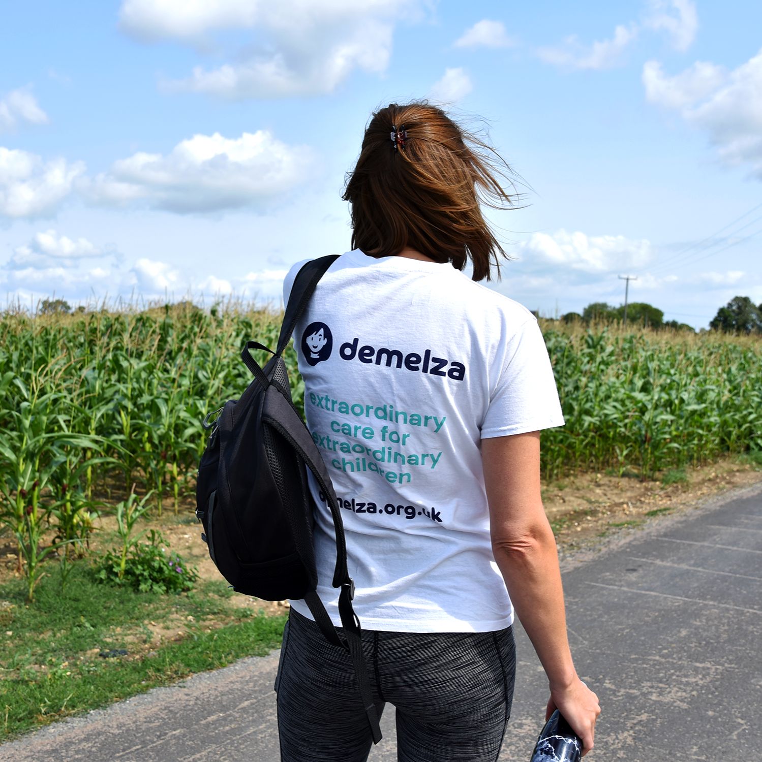 Lady standing with back to camera in a Demelza top