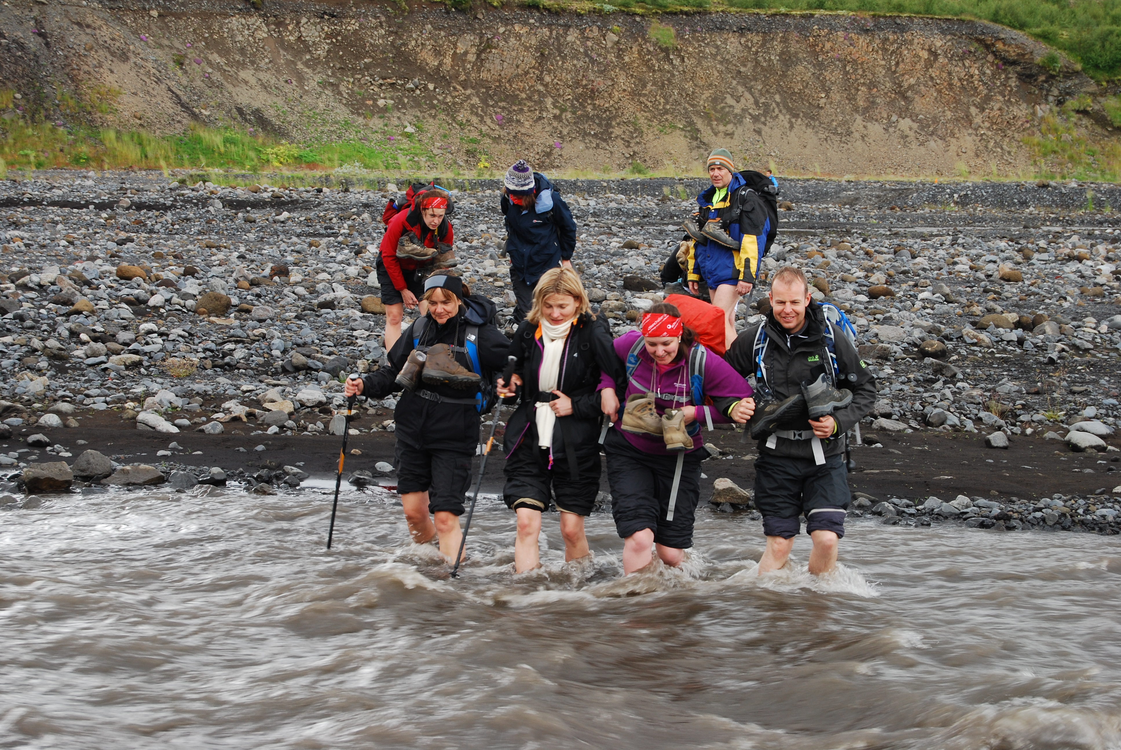 Trekkers crossing a river