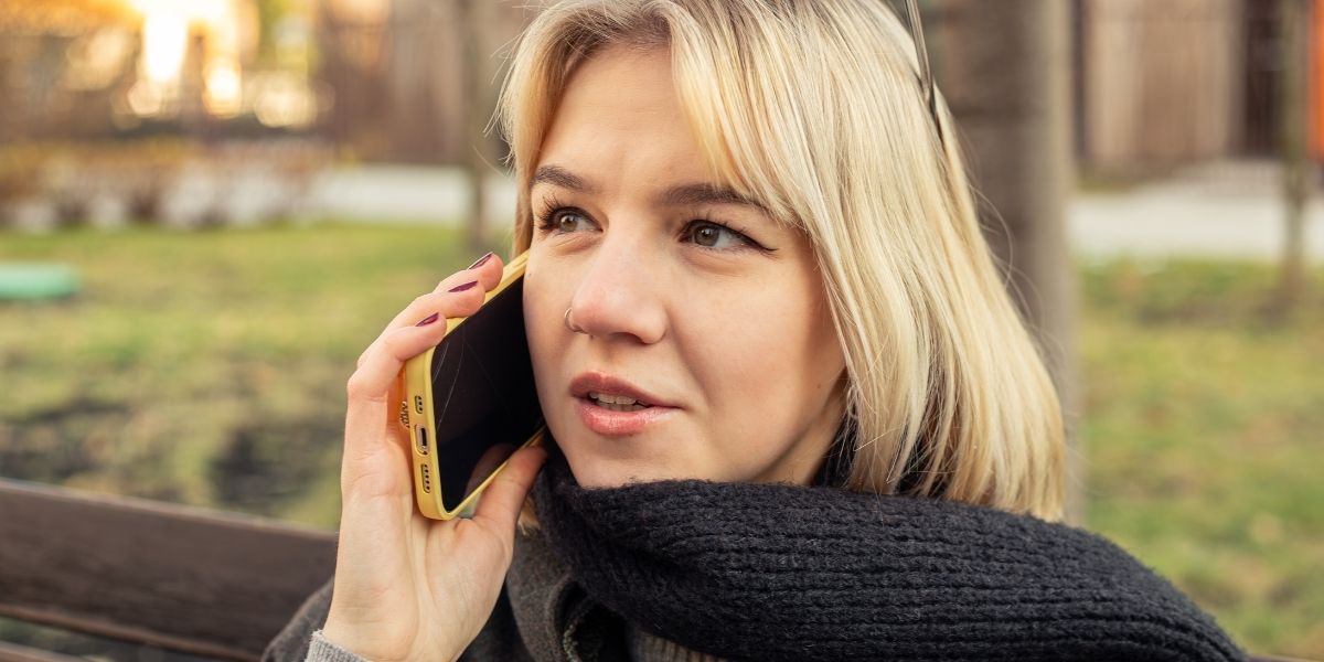 Woman phoning domestic violence helpline