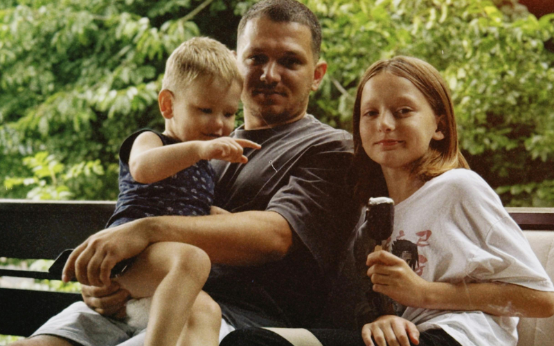 father and two kids on bench father and two kids on bench