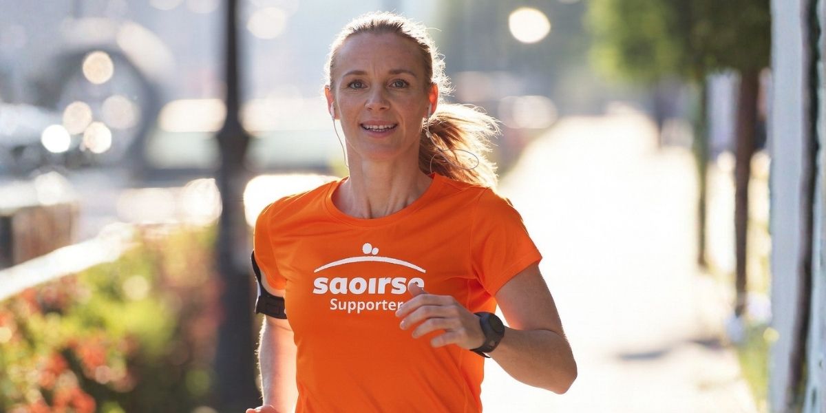 Woman running wearing a Saoirse t-shirt