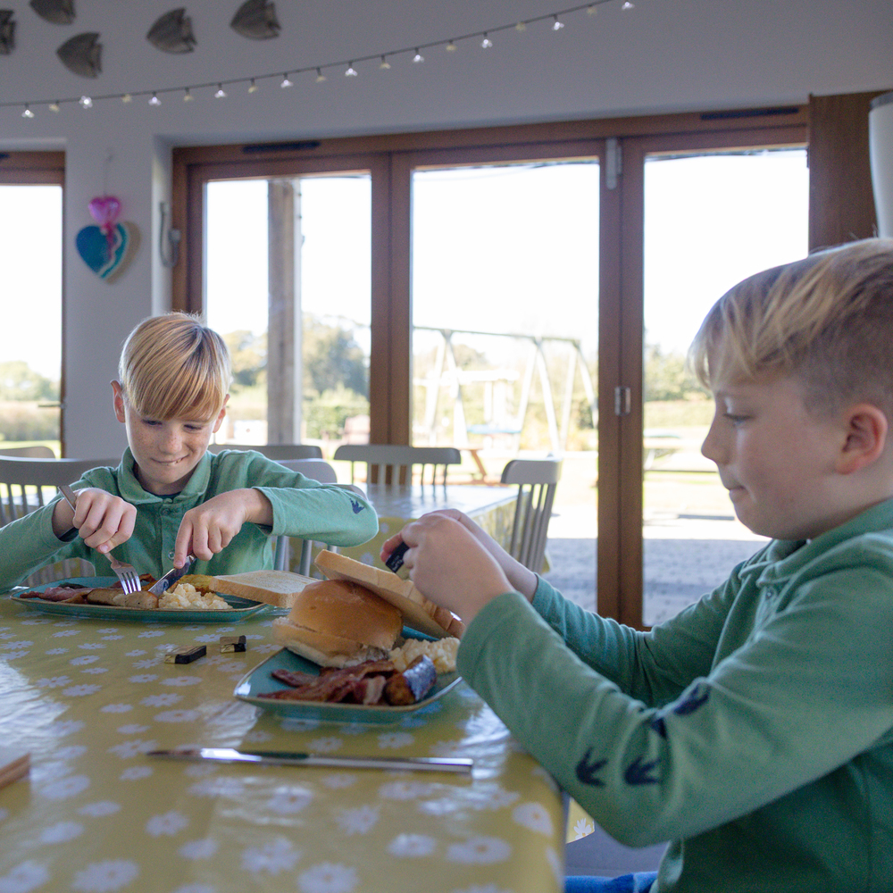 boys eating burgers at the hospice