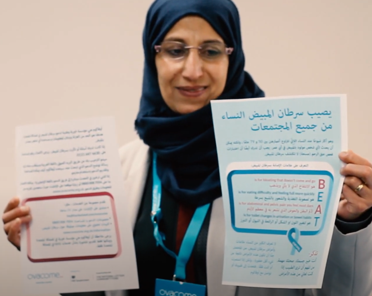 A lady holding BEAT symptoms information leaflets in other languages A lady holding BEAT symptoms information leaflets in other languages