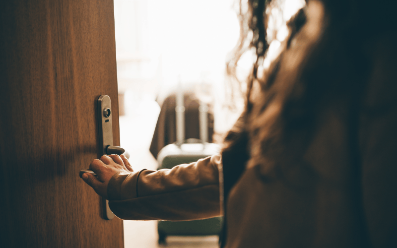 cropped image woman opening door