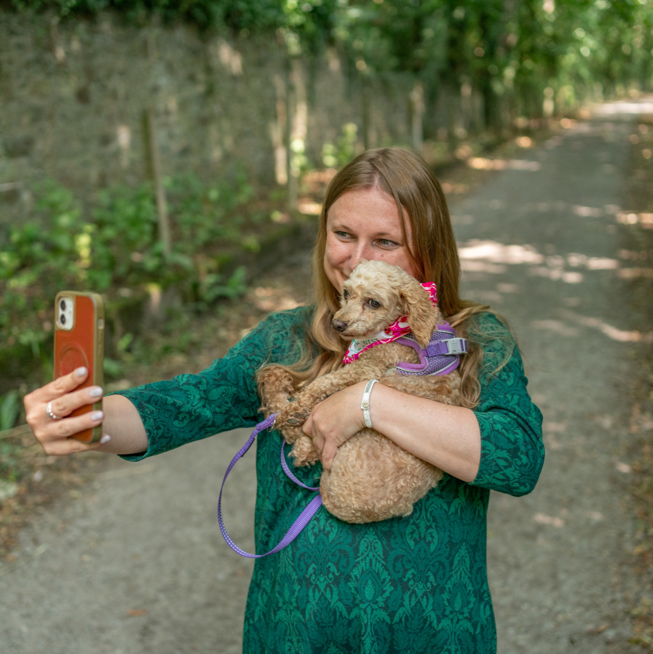 woman taking a selfi with poodle