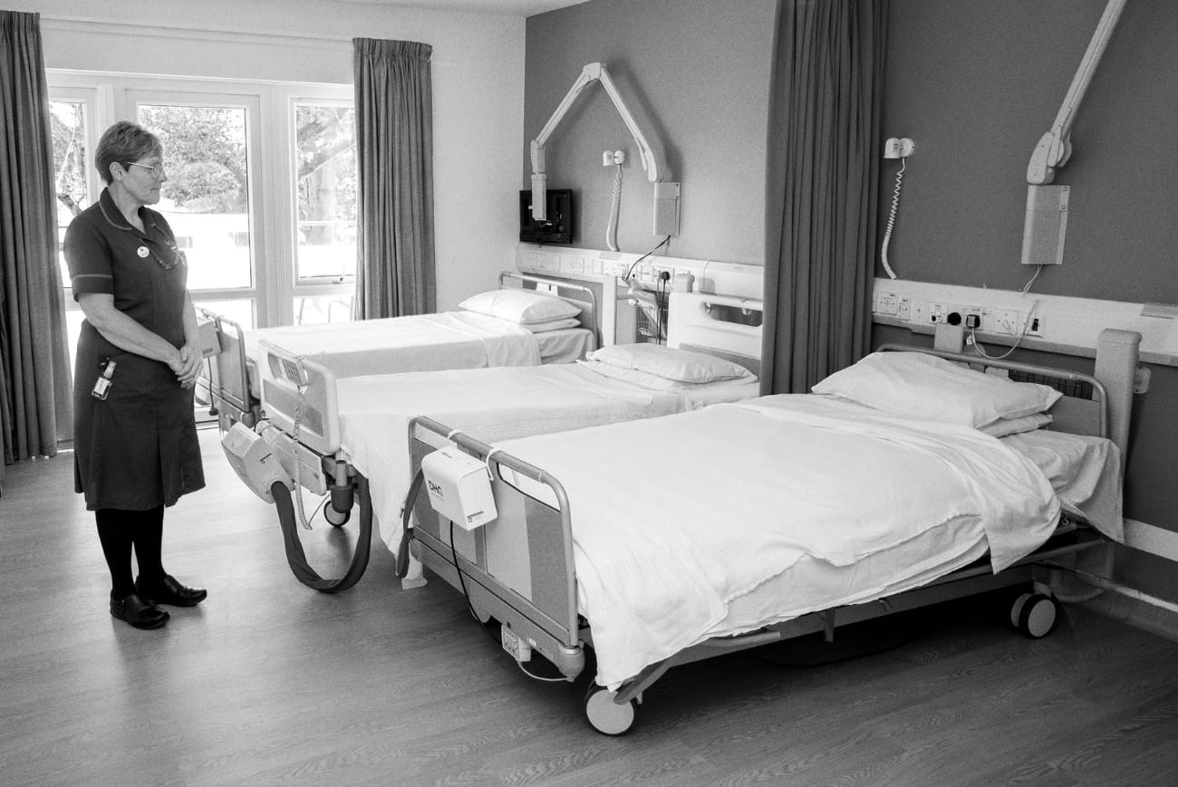 A member of the Myton team standing beside inpatient hospice beds
